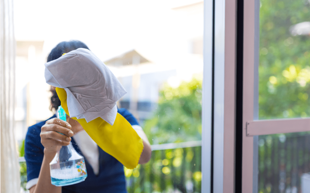 Woman cleaning window from outside