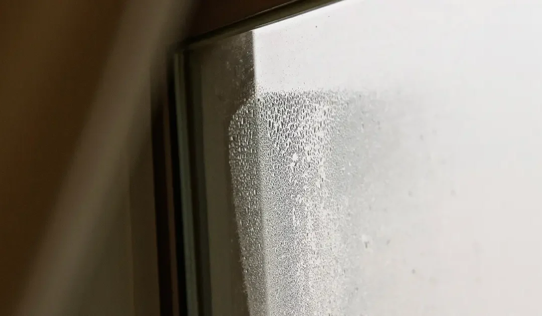 the top corner of a window filled with water caused by blown double glazing